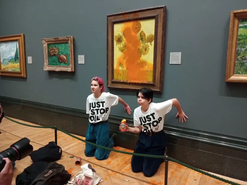 Protesters from the Just Stop Oil movement glue themselves to a painting in an art gallery