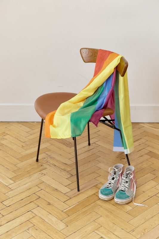 Photo of Pride flag draped over chair