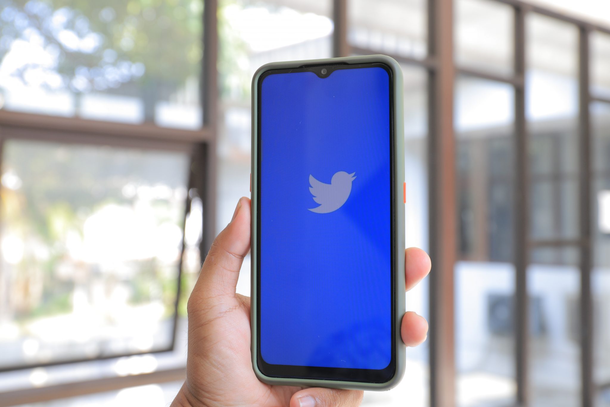 Photo of phone with Twitter logo on screen