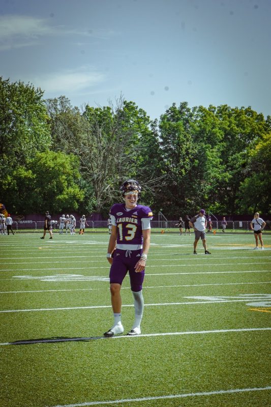 Laurier football player standing on field