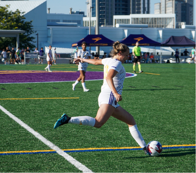 Laurier Soccer player going to kick ball
