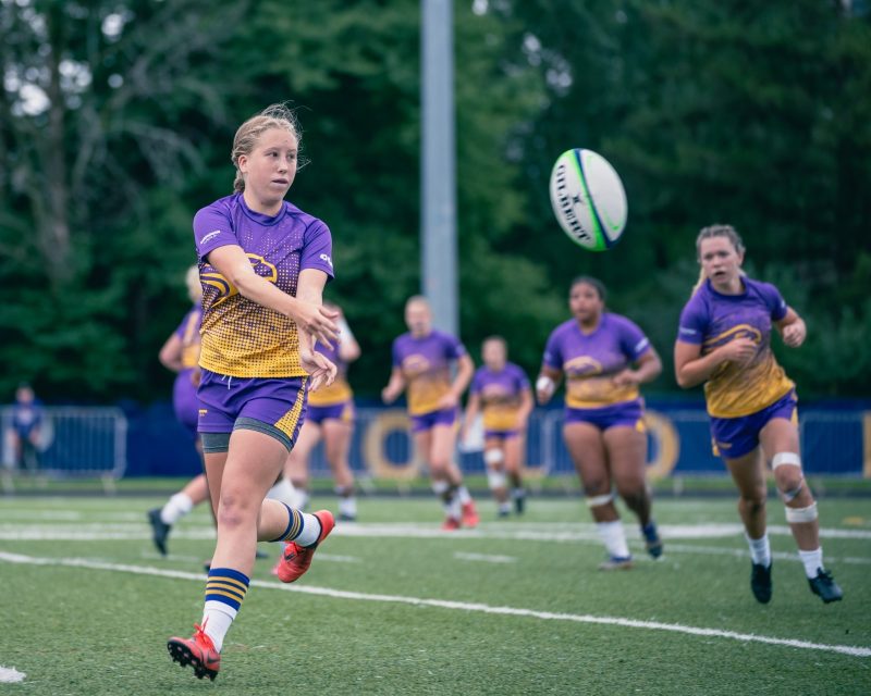 Laurier womens rugby team - player on the field throwing a ball